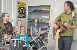  ?? ERIC MCCARTHY/JOURNAL PIONEER ?? Bloomfield Elementary School choir members Violet MacNeill, on drums along with Brook Arsenault, left, Madeline Oliver and Ciara Shaw watch for a cue from their music teacher, Devin Krauskopf, before launching into “Star of Christmas.” The choir’s...