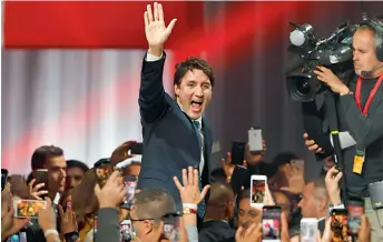  ?? — AFP ?? Prime minister Justin Trudeau celebrates his victory with his supporters at the Palais des Congres in Montreal on Tuesday.