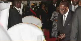  ??  ?? President Mugabe pays last respects to late national heroes Cdes Maud Muzenda and George Rutanhire at Stodart Hall in Harare yesterday. See more stories on Page 2