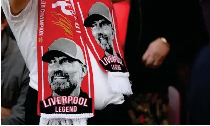  ?? Photograph: Paul Greenwood/Shuttersto­ck ?? A Liverpool fan wears a Jürgen Klopp scarf in the stands at Anfield, where the manager hopes he won’t be joining them for Wolves’ visit.