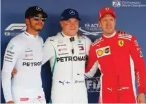  ?? – Reuters ?? TOP THREE: Mercedes’ Valtteri Bottas, centre, after qualifying in pole position with teammate Lewis Hamilton, left, and Ferrari’s Sebastian Vettel.