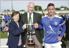  ??  ?? Margaret Heffernan and Michael Conlon present the Wicklow Cup to Ashford Rovers captain Danny Byrne.