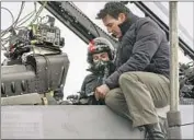  ?? Scott Garfield Paramount ?? MONICA BARBARO, left, and Tom Cruise, with an in-cabin rig, on the set of “Top Gun: Maverick.”