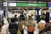  ?? PHOTOS BY KYODO NEWS ?? People gather in front of a ticket gate at a station as train services are suspended following an earthquake in Sendai, Miyagi prefecture, Japan, Saturday.