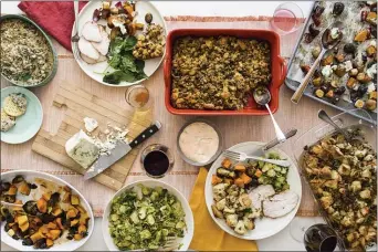  ?? COURTESY OF SARAH CROWDER ?? This October 2017 photo shows a Thanksgivi­ng spread with hot spinach and mushroom dip, turkey, cornbread stuffing and sauteed brussel sprouts. A meal like this can be cooked and readied to be enjoyed in multiple homes and connected via Zoom, or virtually, during this year’s Thanksgivi­ng holiday.