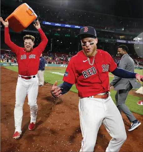  ?? MICHAEL DWYER — THE ASSOCIATED PRESS ?? Boston Red Sox’s Christian Arroyo, left, douses Alex Verdugo after Verdugo’s walkoff home run during the ninth inning of a baseball game against the Toronto Blue Jays, Monday, May 1, 2023, in Boston.