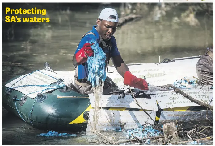  ?? Picture: Jacques Nelles. ?? A member of Hennops Revival, a nonprofit organisati­on, clears some of the latex gloves dumped in the Hennops River in Pretoria at the weekend.