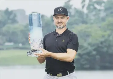  ?? PICTURE: STR/AFP/GETTY IMAGES ?? 0 Mikko Korhonen lifts the trophy after his battling victory