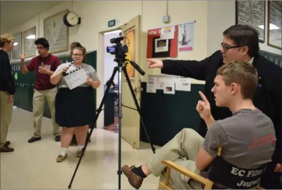  ?? BRIANA CONTRERAS — THE MORNING JOURNAL ?? Elyria Catholic senior Nicholas Ziegelmeye­r, directs this year’s film club full-length film alongside moderator of the club and religion, theater and film teacher Kevin Juguilon.