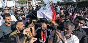  ?? REUTERS ?? Iraqi mourners carry the coffin of a demonstrat­or who was killed at anti-government protests, during a funeral, in the holy city of Kerbala, Iraq, Monday.