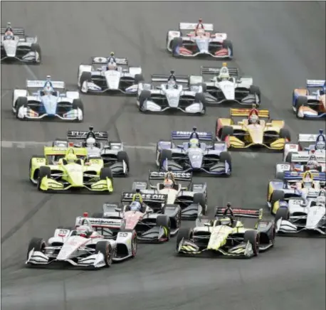  ?? THE ASSOCIATED PRESS ?? Will Power, left, made a late move to win the IndyCar Grand Prix Motor Speedway. for the second straight time Saturday at Indianapol­is