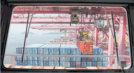  ?? REUTERS ?? A crane carries a container from a ship of Hanjin Shipping at Hanjin container terminal at the Busan New Port in Busan, about 420 km (261 miles) southeast of Seoul in this August 8, 2013 file photo.