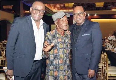  ??  ?? After collecting his award for 51 years of service to the tourism industry, Raft Captain Jasper Roberts (centre) paused for a photograph with Director of Tourism Donovan White (left) and Minister of Tourism Edmund Bartlett.