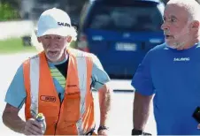  ?? — AP ?? Coming clean: Newburn (left) running with a support crew member on State Highway 1 near Raumati, New Zealand.