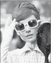  ??  ?? AUDREY HEPBURN checks her look, shades included, for 1966’ s “How to Steal a Million.”
