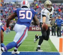  ?? AP PHOTO ?? IT’S A REACH: Drew Brees holds the ball out over the goal line for a touchdown during the Saints’ rout of the Bills yesterday in Orchard Park, N.Y.