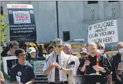  ?? Andrew Selsky Associated Press ?? GUN CONTROL supporters rally outside Oregon’s Capitol in Salem before turning in signatures in July.