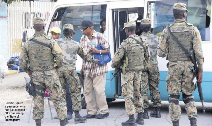  ??  ?? Soldiers search a passenger who had just stepped off a bus during the State of Emeregency.