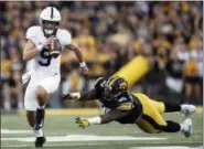  ?? JEFF ROBERSON — THE ASSOCIATED PRESS FILE ?? Penn State quarterbac­k Trace McSorley (9) runs with the ball as Iowa defensive lineman Cedrick Lattimore can’t reach him during the first half of a game last season in Iowa City, Iowa. The 17th-ranked Nittany Lions begin the three-game gantlet of Iowa (home), Michigan (road) and Wisconsin (home) and will need to keep their offense chugging to get through it.