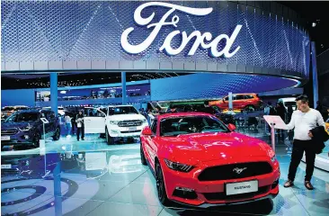  ?? JOHANNES EISELE / AFP / GETTY IMAGES FILES ?? The new Ford Mustang at the Shanghai auto show earlier this year. Ford has inked a joint venture deal to manufactur­e and sell electric and connected cars in China