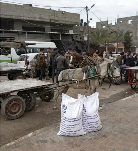  ?? EPA ?? Top left, boxes of dates donated for Gaza at a warehouse in Cairo; above, UNRWA aid in the city of Rafah in the enclave