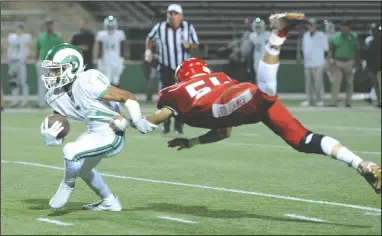  ?? BEA AHBECK/NEWS-SENTINEL ?? Lodi's Daniel Kraft tackles St. Mary's Dumanier Cotton during their game at the Grape Bowl in Lodi on Friday.