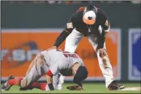  ?? The Associated Press ?? BOSTON’S ELDER: Boston Red Sox second baseman Dustin Pedroia, left, struggles to stand after colliding with Baltimore Orioles’ Manny Machado during the eighth inning of an April 21, 2017, game in Baltimore. Pedroia is sidelined for the remainder of the 2018 season with a knee injury stemming from the collision.