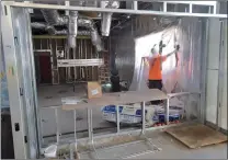  ?? Dan Watson/The Signal ?? (Above) Constructi­on work continues in the training kitchen of the Canyon Country Community Center. (Right) A group views the progress in the lobby of the community center during a tour led by Santa Clarita Parks Planning Manager Wayne Weber on Thursday.