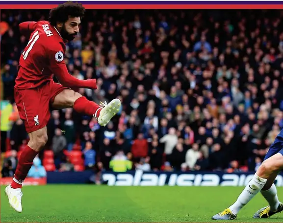  ??  ?? Explosive: Mohamed Salah unleashes his shot and Jorginho winces helplessly as the ball heads for the top corner of Chelsea’s net and fires Liverpool into a 2-0 lead