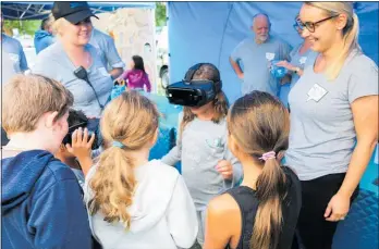  ?? Photo / Supplied ?? Waipa¯ District Council acting communicat­ion and engagement manager Nicole Nooyen (right) shows children the virtual reality goggles.