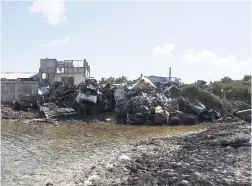  ??  ?? In this November 4, 2015 file photo, a large pile of rubbish made up of wrecked cars, washing machines and old fridges are stacked high to form a makeshift sea wall on Majuro Atoll in the Marshall Islands.