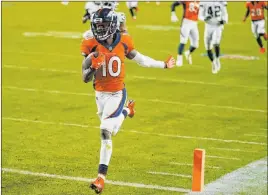  ?? Jack Dempsey The Associated Press ?? Denver Broncos wide receiver Jerry Jeudy scores a 92-yard touchdown against the Raiders on Sunday. Jeudy finished with five catches for 140 yards.