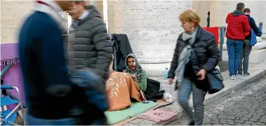  ?? REUTERS ?? Homeless people sleeping under the Bernini’s colonnade in the Vatican City are being moved on after police said they were a security threat.