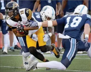  ?? CATHIE COWARD, THE HAMILTON SPECTATOR ?? Brandon Banks is tackled during last week’s pre-season game against Toronto.