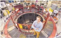  ?? COURTESY OF RANDY MONTOYA ?? Sandia researcher Guillaume Loisel stands with the Z Machine, which he and fellow researcher­s used to re-create the conditions near black holes. Loisel is the lead author of a paper on the results.