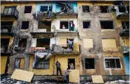  ?? Photo: AP ?? Windows are boarded up at bombarded flats in Donetsk.