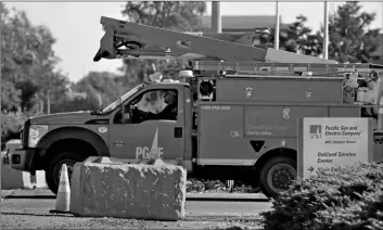  ?? AP Photo/Ben Margot ?? In this Feb. 11 file photo a Pacific Gas & Electric truck leaves the company’s Oakland Service Center in Oakland, Calif.