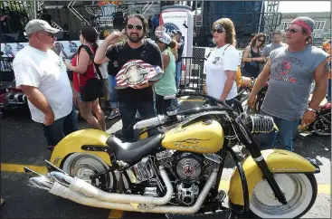  ?? NWA Democrat-Gazette/MICHAEL WOODS • @NWAMICHAEL­W ?? Scotty Robertson from Steele, Mo., reacts Saturday after winning the Best of Show at the Battle of the Bikes competitio­n during the annual Bikes, Blues & BBQ motorcycle rally in Fayettevil­le. Robertson, also known as “Memphis” by his friends, has won...