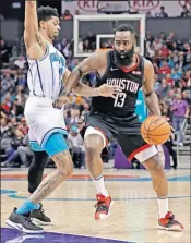  ?? [AP PHOTO/CHUCK BURTON] ?? Houston Rockets' James Harden drives against Charlotte Hornets' Jeremy Lamb during the second half Wednesday in Charlotte, N.C.