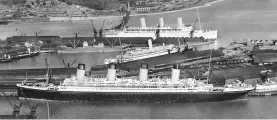  ??  ?? In the foreground of this picture from 1933 is the liner “Olympic”, sister ship to the ill-fated “Titanic” and “Britannic”. In the background is “Empress of Britain”, the largest liner to be sunk during the Second World War (see England’s Maritime...