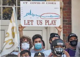  ?? SHAWN MCFARLAND/HARTFORD COURANT ?? High school football players protested in West Hartford against the CIAC’s decision to disallow full contact football games this fall.