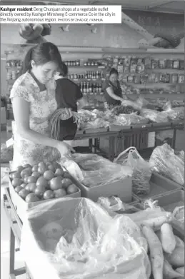  ?? PHOTOS BY ZHAO GE / XINHUA ?? Kashgar resident Deng Chunjuan shops at a vegetable outlet directly owned by Kashgar Minsheng E-commerce Co in the city in the Xinjiang autonomous region.