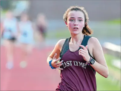  ?? TIM MARTIN/ THE DAY ?? East Lyme junior Gilly Goodwin approaches the finish line to finish in second place during a triteam meet on Tuesday at Stonington. Goodwin led the Vikings, last years’ ECC champion, to wins over Stonington and Bacon Academy.