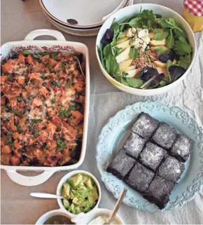  ?? ASHLEIGH SPITZA ?? Black bean and squash casserole, apple-pear salad and sweet potato brownies make for a colorful, flavor-packed menu.