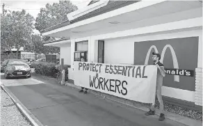  ?? BEN MARGOT ?? Protesting what they say is a lack of personal protective equipment, employees close the drive- thru at a McDonald's in Oakland, Calif., last month.