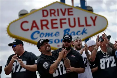  ??  ?? Members of a laborers union celebrate Monday in Las Vegas. NFL team owners approved the move of the Raiders to Las Vegas in a vote at an NFL football annual meeting in Phoenix. AP PHOTO