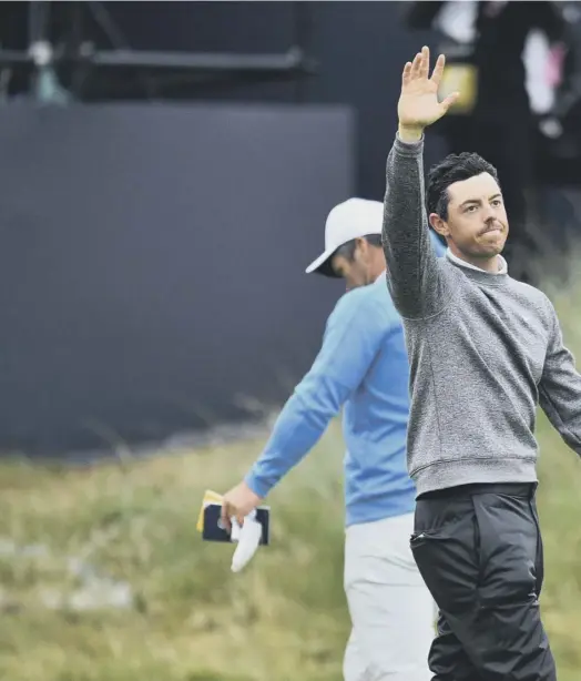  ??  ?? 0 Rory Mcilroy says his farewells after he was afforded a rousing reception at the 18th hole at Portrush. He failed to make the cut at the