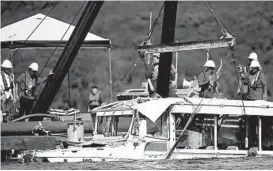  ?? NATHAN PAPES/AP ?? A duck boat that sank in Table Rock Lake in Branson, Missouri, is raised July 23, 2018.