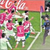  ?? AFP ?? Ghana's Mohammed Kudus celebrates with the substitute­s after scoring against South Korea at the Education City Stadium.