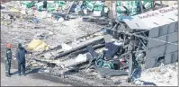  ?? CP PHOTO ?? Cargo carried by a tractor trailer and hockey equipment bags are strewn around the site of Friday’s crash that involved the Humboldt Broncos’ team bus.